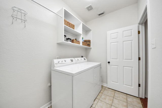 3214 Oak Park Ln, Missouri City, TX 77459 - laundry room featuring washer and dryer and light tile patterned floors