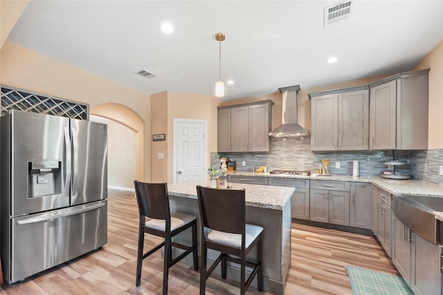 1415 Pony Ln, Simonton, TX 77485 - kitchen with stainless steel appliances, wall chimney exhaust hood, light wood-style flooring, gray cabinetry, and recessed lighting