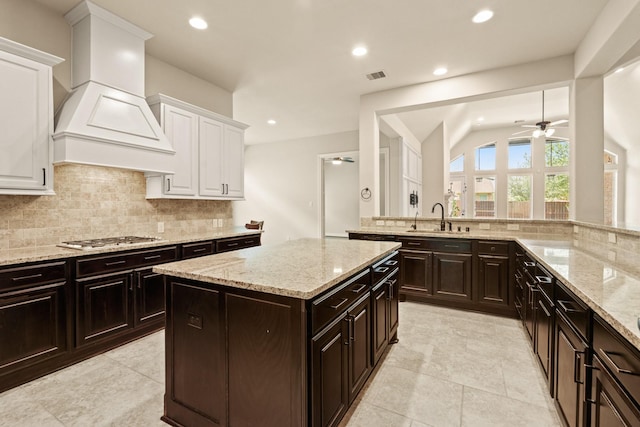 1719 Quail Ridge Dr, Katy, TX 77493 - kitchen featuring stainless steel gas cooktop, white cabinets, tasteful backsplash, ceiling fan, and recessed lighting