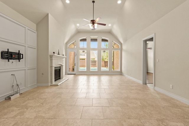 1719 Quail Ridge Dr, Katy, TX 77493 - unfurnished living room with ceiling fan, recessed lighting, a glass covered fireplace, vaulted ceiling, and light tile patterned flooring