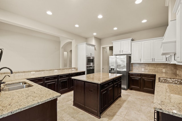1719 Quail Ridge Dr, Katy, TX 77493 - kitchen with appliances with stainless steel finishes, custom range hood, tasteful backsplash, white cabinets, and recessed lighting
