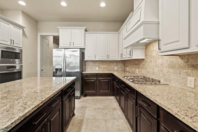 1719 Quail Ridge Dr, Katy, TX 77493 - kitchen with stainless steel appliances, white cabinets, light stone countertops, and recessed lighting