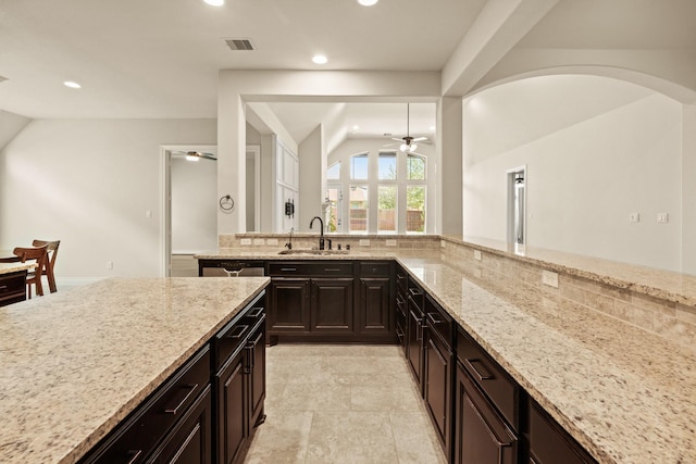 1719 Quail Ridge Dr, Katy, TX 77493 - kitchen featuring ceiling fan, lofted ceiling, recessed lighting, light stone countertops, and decorative backsplash