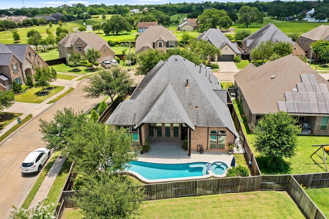 1719 Quail Ridge Dr, Katy, TX 77493 - view of swimming pool featuring a fenced backyard, a residential view, a pool with connected hot tub, and a patio area