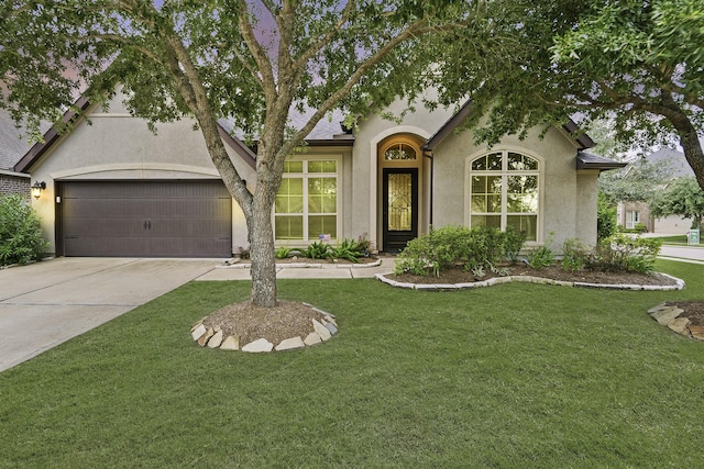 1719 Quail Ridge Dr, Katy, TX 77493 - tudor home with stucco siding, concrete driveway, a front yard, and an attached garage