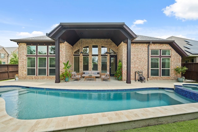 1719 Quail Ridge Dr, Katy, TX 77493 - rear view of property featuring outdoor lounge area, brick siding, a patio area, and a pool with connected hot tub