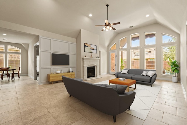 1719 Quail Ridge Dr, Katy, TX 77493 - living area featuring lofted ceiling, a ceiling fan, recessed lighting, a fireplace with raised hearth, and light tile patterned floors