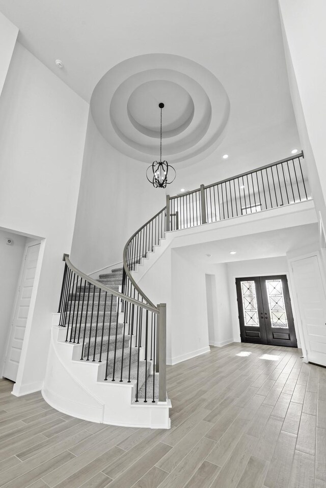 2806 Nova Beach Dr, Texas City, TX 77568 - entrance foyer with a towering ceiling, french doors, stairs, a tray ceiling, and a chandelier