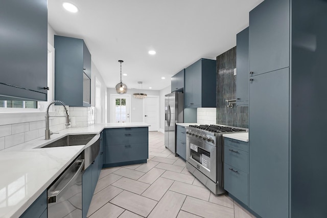 3343 Tampa St, Houston, TX 77021 - kitchen with stainless steel appliances, decorative backsplash, a peninsula, light stone counters, and pendant lighting