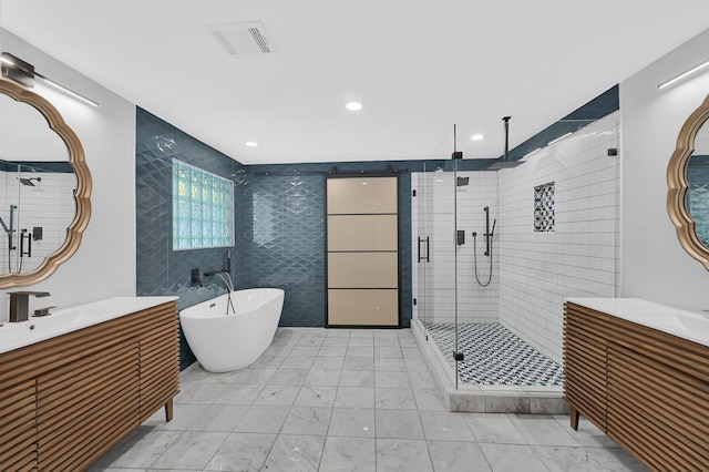 3343 Tampa St, Houston, TX 77021 - full bathroom with a stall shower, two vanities, a soaking tub, tile walls, and recessed lighting