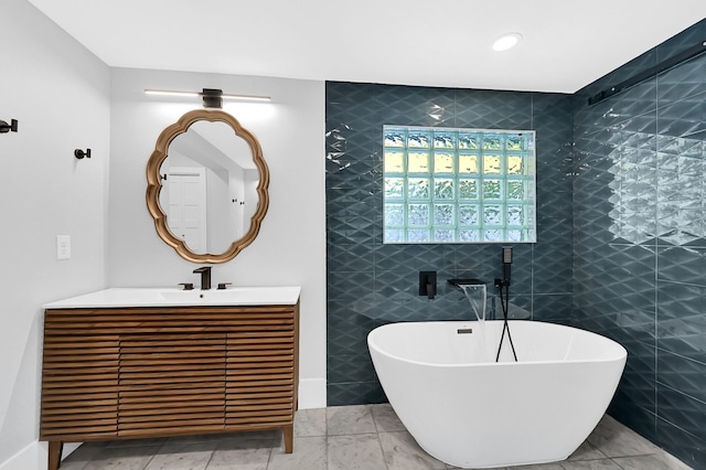 3343 Tampa St, Houston, TX 77021 - bathroom featuring a soaking tub, vanity, and tile walls
