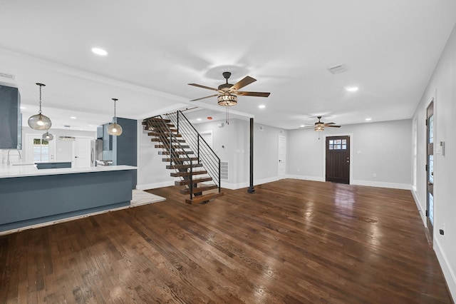3343 Tampa St, Houston, TX 77021 - unfurnished living room featuring ceiling fan, stairs, wood finished floors, and recessed lighting