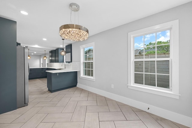 3343 Tampa St, Houston, TX 77021 - kitchen featuring freestanding refrigerator, a peninsula, light countertops, hanging light fixtures, and recessed lighting