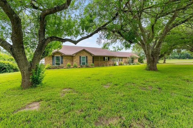 4205 Wade Rd, Brookshire, TX 77423 - ranch-style home featuring a front yard and brick siding