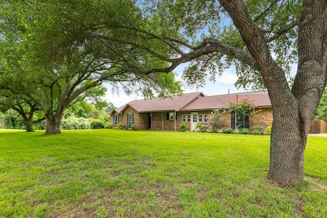 4205 Wade Rd, Brookshire, TX 77423 - single story home with a front lawn and brick siding