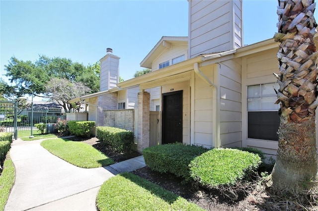 13002 Leader Unit 906, Houston, TX 77072 - view of exterior entry with a chimney