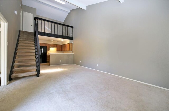 13002 Leader Unit 906, Houston, TX 77072 - unfurnished living room with stairway, beam ceiling, light colored carpet, and high vaulted ceiling