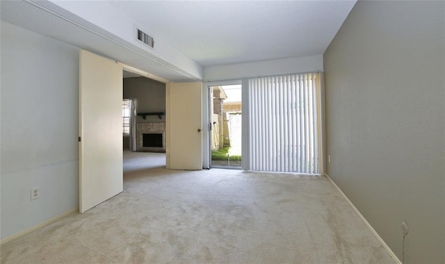 13002 Leader Unit 906, Houston, TX 77072 - carpeted spare room with plenty of natural light and a fireplace