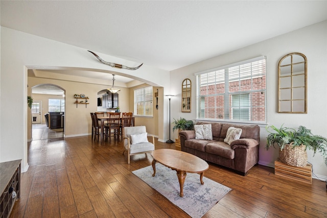 8234 Nagy Hill St, Spring, TX 77379 - living area with arched walkways, hardwood / wood-style flooring, and plenty of natural light