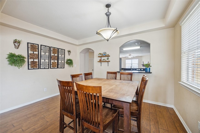 8234 Nagy Hill St, Spring, TX 77379 - dining space with arched walkways, hardwood / wood-style floors, a raised ceiling, and ceiling fan