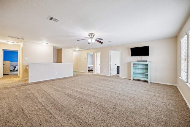 8234 Nagy Hill St, Spring, TX 77379 - unfurnished living room featuring ceiling fan, carpet floors, and plenty of natural light