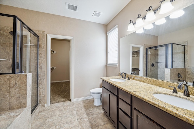 8234 Nagy Hill St, Spring, TX 77379 - bathroom featuring a walk in closet, a stall shower, double vanity, and tile patterned flooring