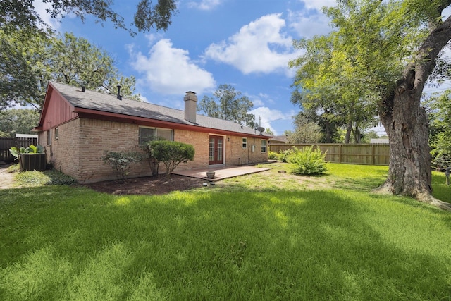 7539 Jason St, Houston, TX 77074 - rear view of property featuring brick siding, a chimney, french doors, and a patio area
