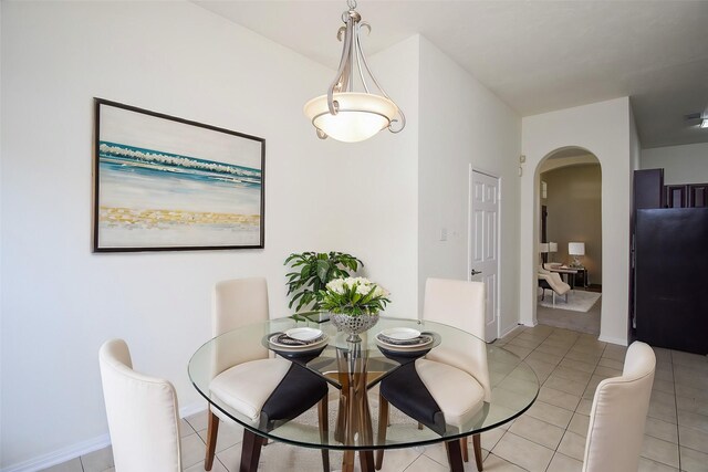 21335 Riverside Ridge Ln, Katy, TX 77449 - dining area featuring arched walkways and light tile patterned floors