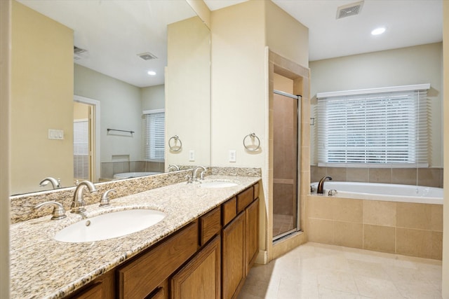 9007 Harbor Hills Dr, Houston, TX 77054 - bathroom featuring a bath, double vanity, a shower stall, tile patterned floors, and recessed lighting