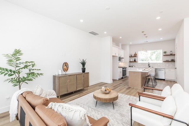 1615 Erin St, Houston, TX 77009 - living room featuring light wood-style floors and recessed lighting