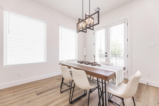 1615 Erin St, Houston, TX 77009 - dining room with light wood-type flooring and a chandelier