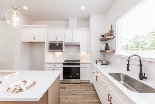 1615 Erin St, Houston, TX 77009 - kitchen with stainless steel appliances, light countertops, white cabinets, and recessed lighting