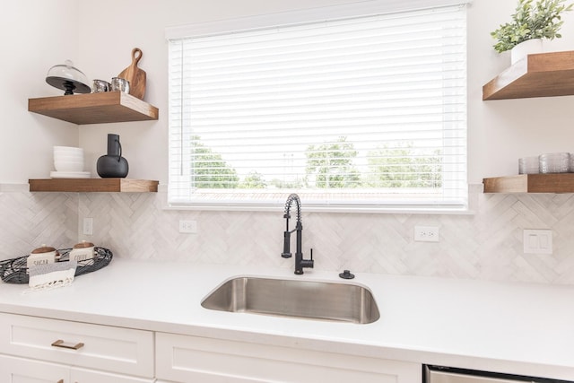 1615 Erin St, Houston, TX 77009 - kitchen with open shelves, tasteful backsplash, and white cabinetry