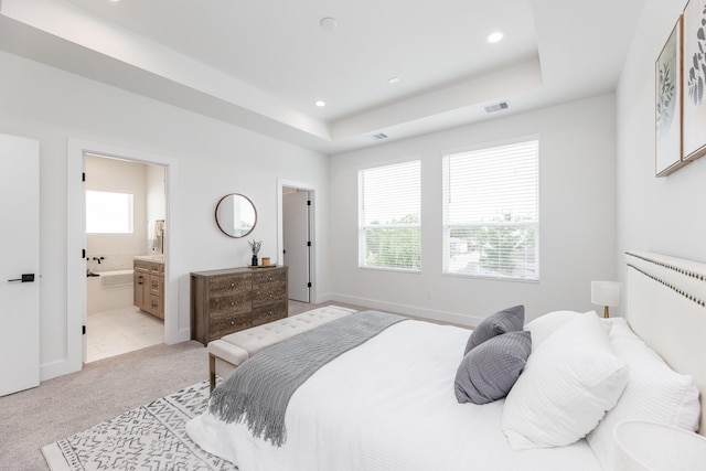 1615 Erin St, Houston, TX 77009 - bedroom with recessed lighting, a tray ceiling, light colored carpet, and ensuite bathroom