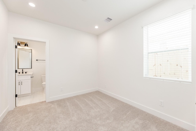1615 Erin St, Houston, TX 77009 - empty room featuring light colored carpet and recessed lighting