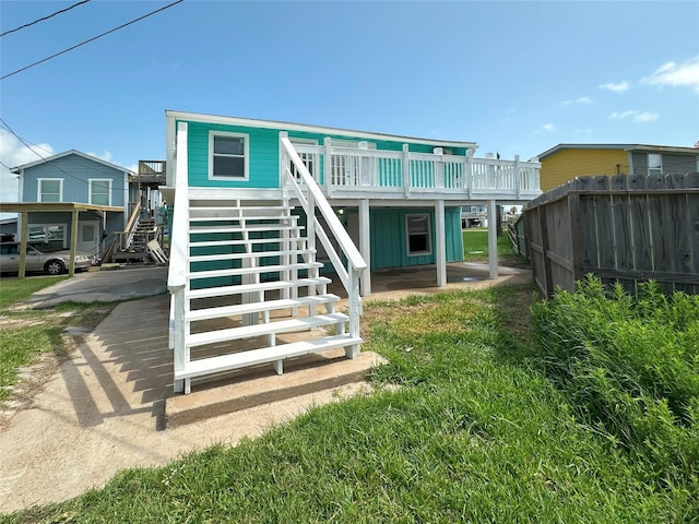 323 Texas St, Freeport, TX 77541 - rear view of house featuring stairway and a wooden deck