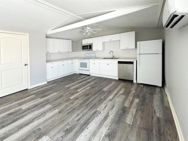 323 Texas St, Freeport, TX 77541 - kitchen featuring stainless steel appliances, a wall mounted air conditioner, dark wood-style floors, light countertops, and tasteful backsplash