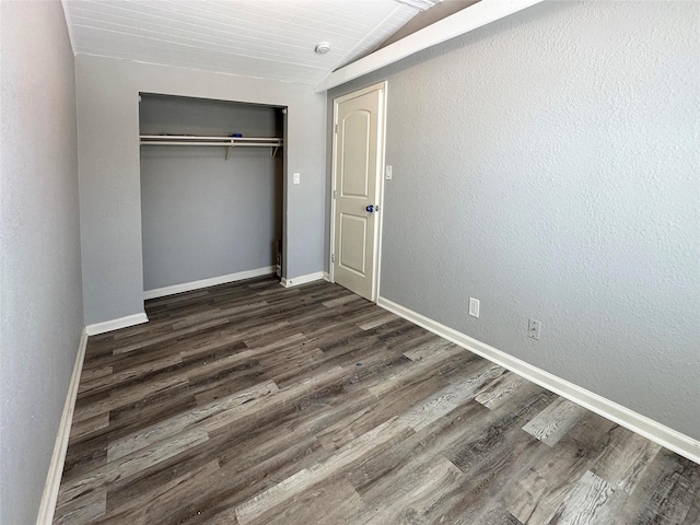 323 Texas St, Freeport, TX 77541 - unfurnished bedroom with dark wood-style flooring, vaulted ceiling, a closet, and wood ceiling