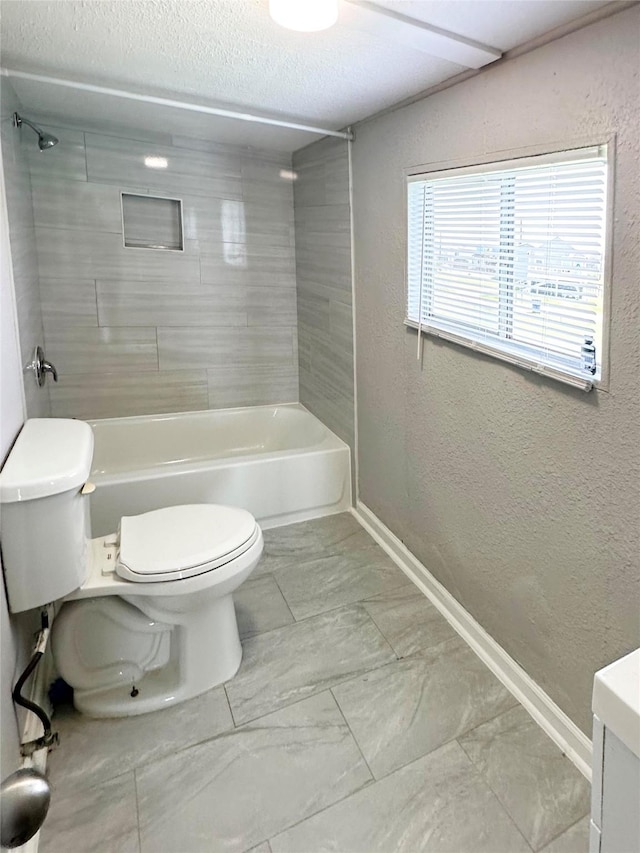 323 Texas St, Freeport, TX 77541 - full bathroom with a textured wall, marble look tiles, a textured ceiling, vanity, and shower / bathtub combination