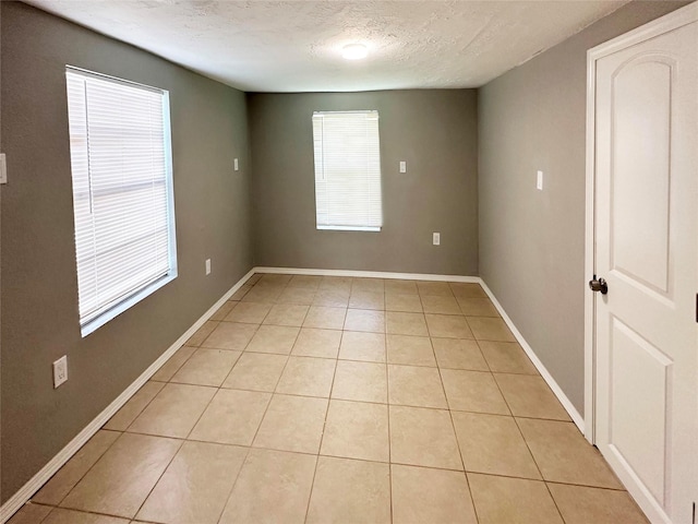 323 Texas St, Freeport, TX 77541 - empty room featuring plenty of natural light, light tile patterned floors, and a textured ceiling