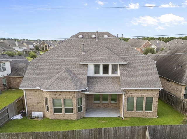6126 Garden Lakes Ln, Sugar Land, TX 77479 - back of house featuring brick siding, a shingled roof, a fenced backyard, a patio, and a residential view
