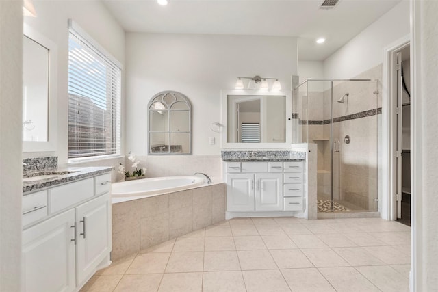 6126 Garden Lakes Ln, Sugar Land, TX 77479 - bathroom featuring a shower stall, two vanities, tile patterned floors, a bath, and recessed lighting