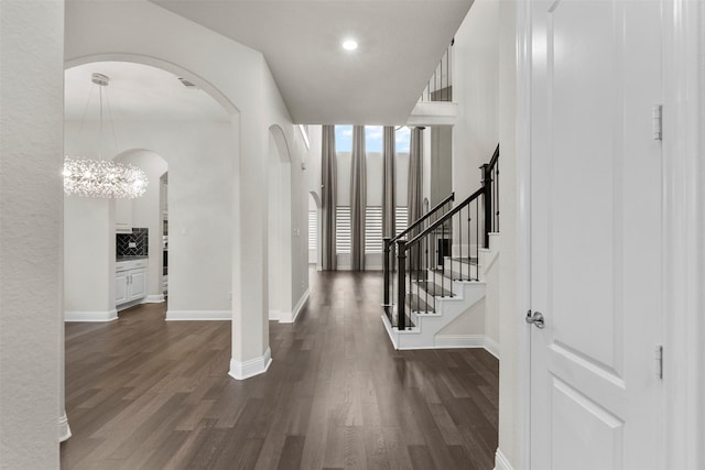 6126 Garden Lakes Ln, Sugar Land, TX 77479 - foyer with arched walkways, dark wood finished floors, recessed lighting, and a chandelier