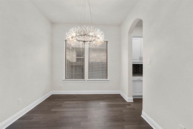 6126 Garden Lakes Ln, Sugar Land, TX 77479 - unfurnished dining area with dark wood finished floors, a chandelier, and arched walkways