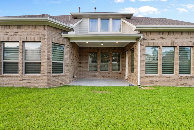 6126 Garden Lakes Ln, Sugar Land, TX 77479 - rear view of property with brick siding, a patio area, a yard, and roof with shingles