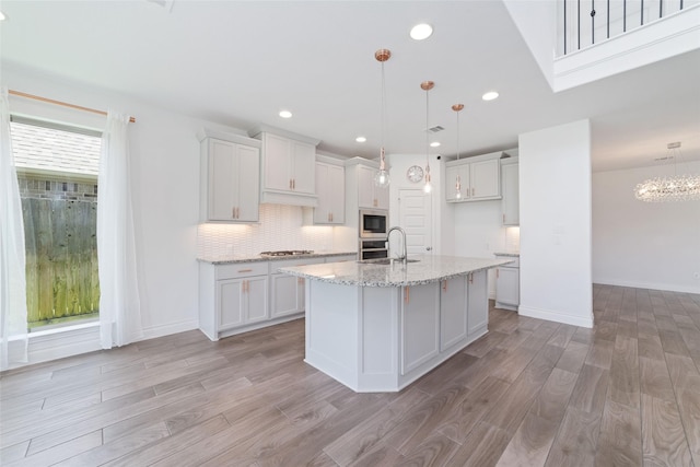 13731 Pedernales Ct, Cypress, TX 77429 - kitchen featuring stainless steel appliances, light wood-type flooring, white cabinets, and recessed lighting