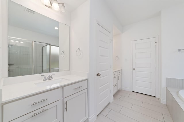 13731 Pedernales Ct, Cypress, TX 77429 - full bathroom featuring vanity, a shower stall, a bath, and tile patterned floors