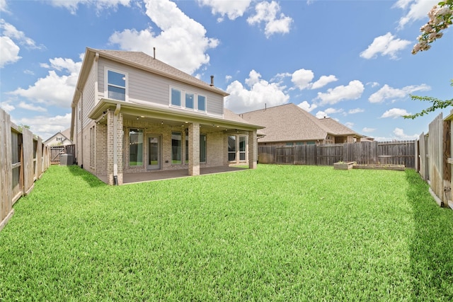 13731 Pedernales Ct, Cypress, TX 77429 - rear view of house featuring brick siding, a fenced backyard, and a patio area