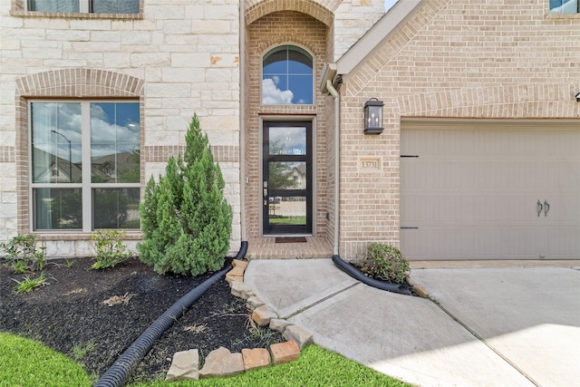 13731 Pedernales Ct, Cypress, TX 77429 - entrance to property featuring brick siding, an attached garage, and driveway
