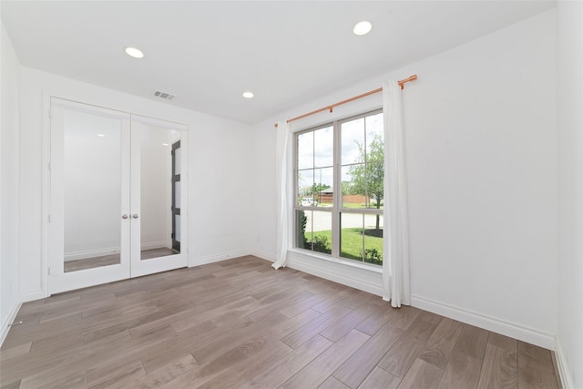 13731 Pedernales Ct, Cypress, TX 77429 - empty room with light wood-type flooring, french doors, and recessed lighting